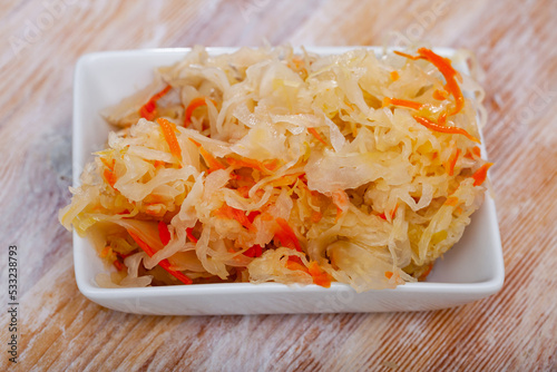 Homemade pickled cabbage on white plate, natural probiotic