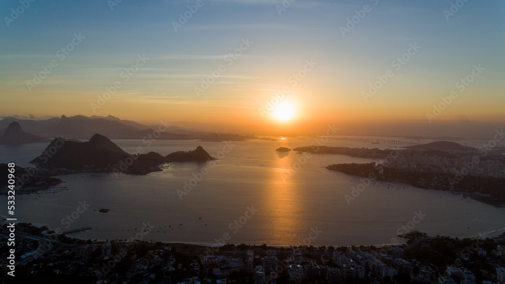 Aerial view of the sunset over Guanabara Bay from the City Park of Niterói. In the background, the mountains Pão-de-Açucar, Corcovado, and Pedra da Gávea, postcards of the city of Rio de Janeiro.