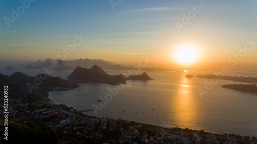 Aerial view of the sunset over Guanabara Bay from the City Park of Niterói. In the background, the mountains Pão-de-Açucar, Corcovado, and Pedra da Gávea, postcards of the city of Rio de Janeiro.