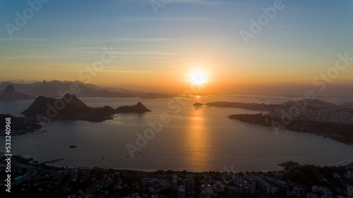 Aerial view of the sunset over Guanabara Bay from the City Park of Niterói. In the background, the mountains Pão-de-Açucar, Corcovado, and Pedra da Gávea, postcards of the city of Rio de Janeiro.
