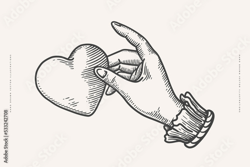 Hand holding a heart in engraving style. Vintage symbol of love on a light background. Vintage vector illustration for postcard, book or tattoo design.