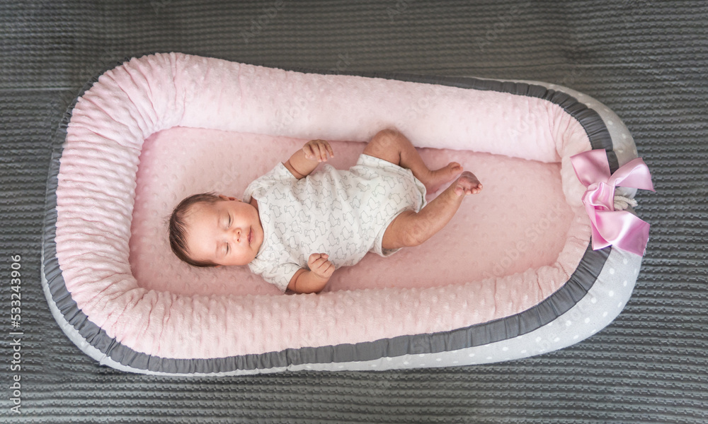 Topview of a sleeping baby girl in a pink crib Topview of a sleeping baby girl in a pink crib