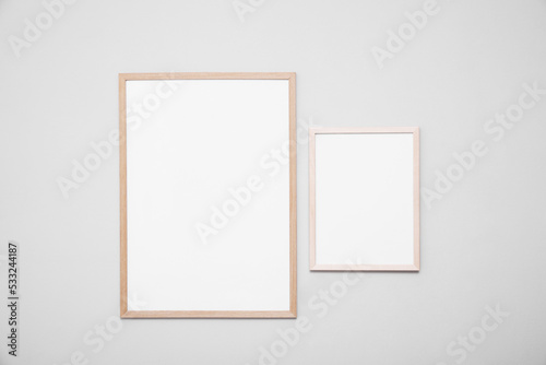 Empty frames on grey wall. Mockup for design