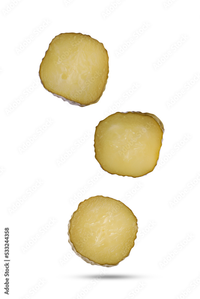 Slices of tasty pickled cucumbers falling on white background