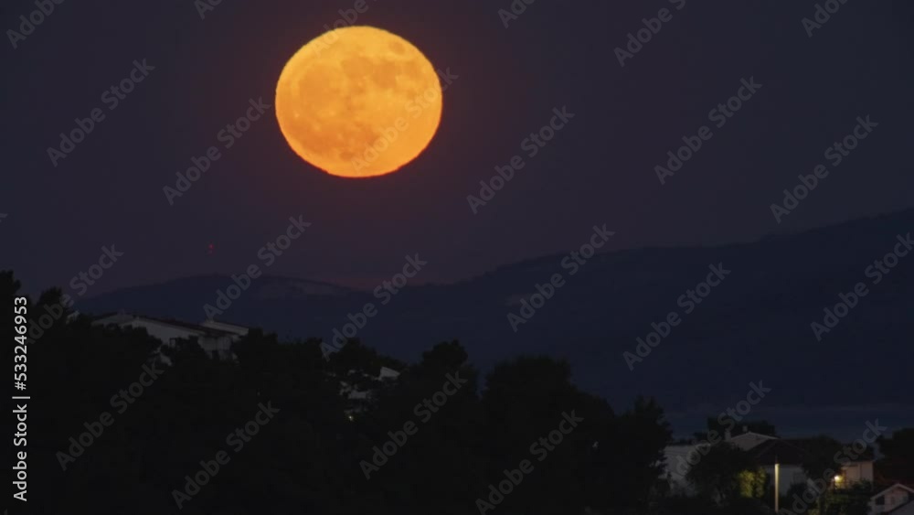 Beautiful full moon in the mountains. The blood moon is orange. Close-up of moonlight in nature. High quality 4k footage