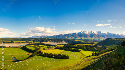 Near the village of Windwhistle looking over agricultural farming fields and the Rakaia Gorge towards Mt Hutt with a slight dusting of snow on the mountain peak