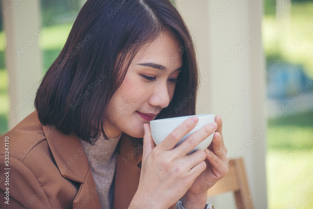 Close up Woman hand holding black coffee cup in green garden cafe. Hands of businesswoman love drinking hot coffee. business women with black coffee or hot chocolate in coffee shop. Caffeine drinking Close up Woman hand holding black coffee cup in green garden cafe. Hands of businesswoman love drinking hot coffee. business women with black coffee or hot chocolate in coffee shop. Caffeine drinking