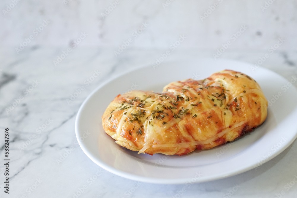Sausage buns bread. Soft baked bun (dough) stuffed with sausage for fast food breakfast or coffee break. Sausage roll, (hot dog). With mayo, tomato sauce, mozarella cheese and parsley topping