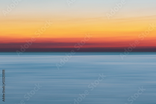 sunset over the ocean © budi