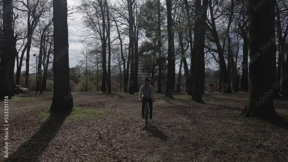 man biking towards the camera while it pushes out, high fps, in the woods man biking towards the camera while it pushes out, high fps, in the woods