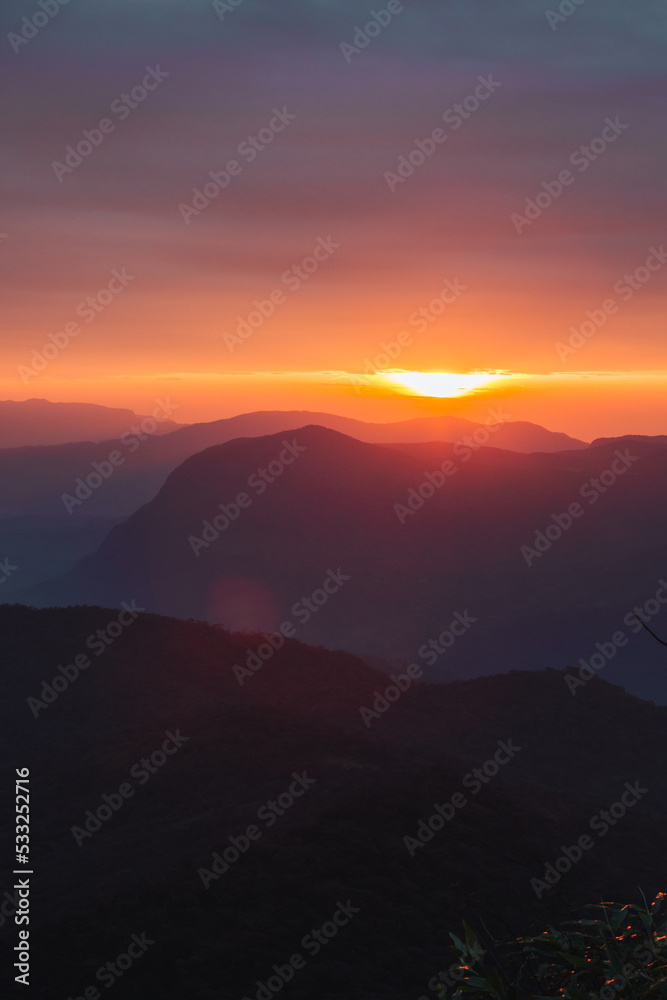 Sunrise over the mountains from Adam's Peak