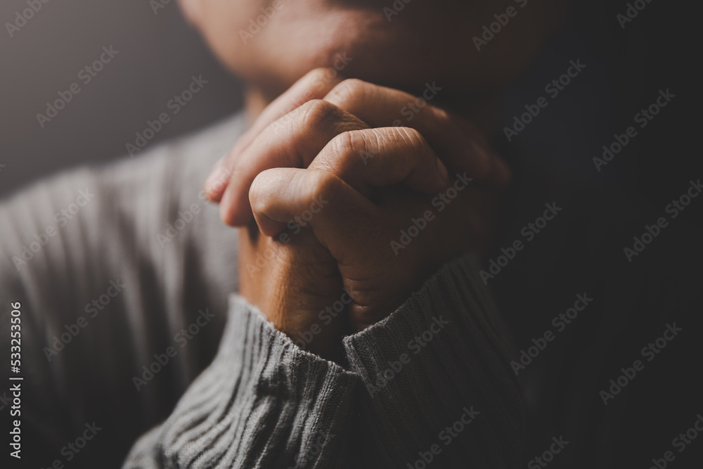 Christ religion and christianity worship or pray concept. Christian catholic woman are praying to god in dark at church. Prayer person hand in black background. Girl believe and faith in jesus christ. - obrazy, fototapety, plakaty 