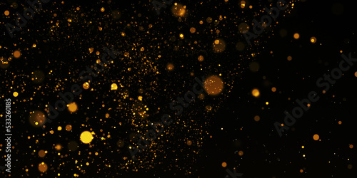 Gold Particle Glitter Luxury Background. Falling gold confetti with magic light. Gold particles glisten in the air