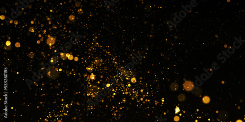 Gold Particle Glitter Luxury Background. Falling gold confetti with magic light. Gold particles glisten in the air