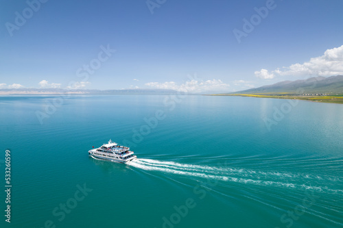 Yacht sailing on Qinhai lake at sunny day.Beautiful clouds in the background. Luxury yacht in the sea.