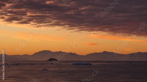 Colorful sunset  with clouds glowing with pink light  at Cierva Cove  Antarctica