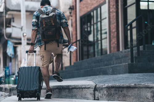 Tourists drag their luggage to check in at the hotel they reserved. Travel concept..