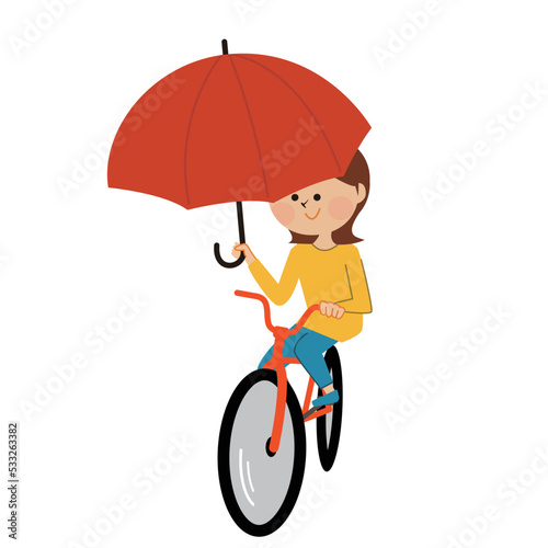 傘を差し自転車に乗る女性