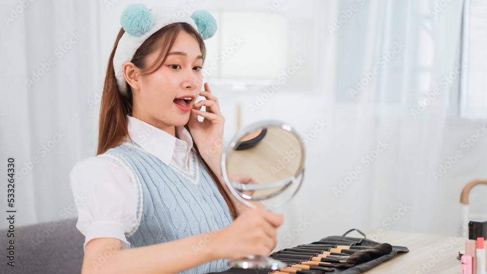 Beauty blogger concept, Asian woman touch face of glow skin to advising skincare in live streaming