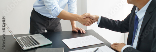 Concept of lawyer counseling, Businessman and senior lawyer shake hands after negotiating deal
