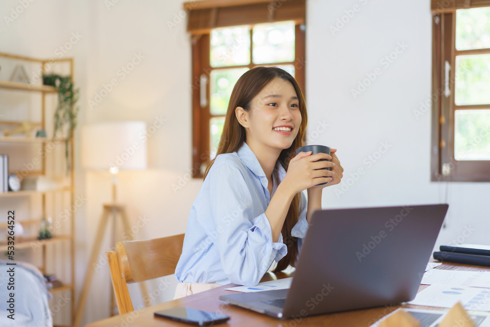 Remote business concept, Businesswoman drinks coffee and looks outside after working in home office Remote business concept, Businesswoman drinks coffee and looks outside after working in home office