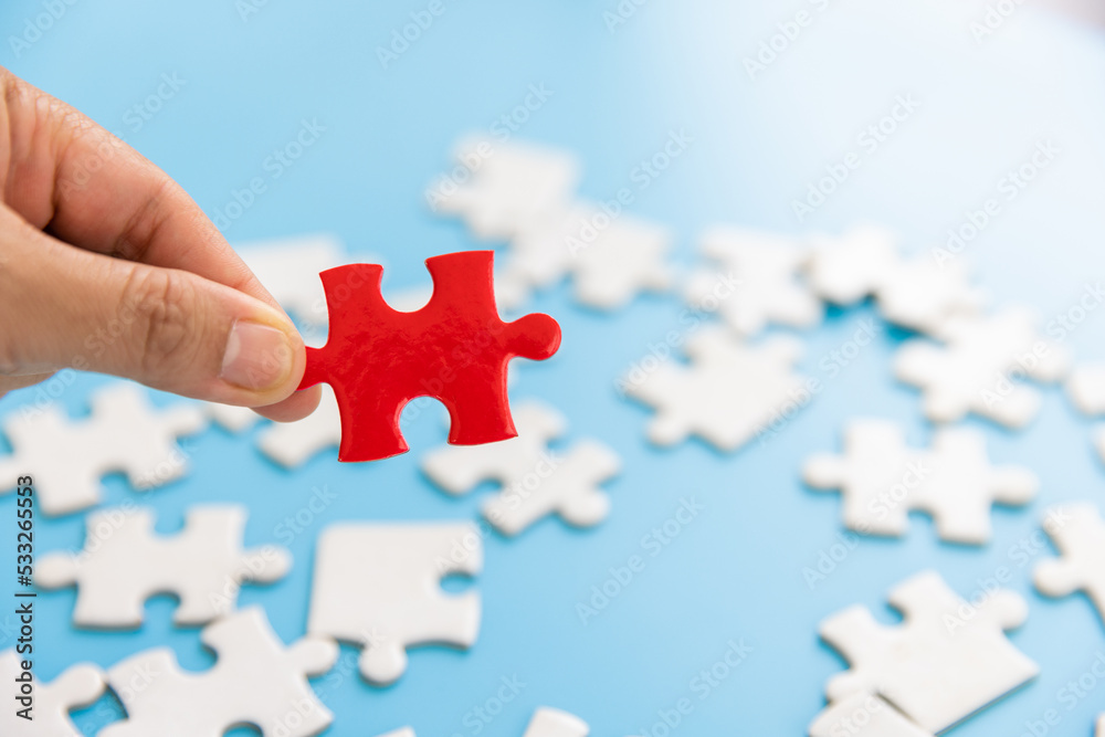 Hand put the last piece of jigsaw puzzle to complete the mission, Business solutions, success and strategy concept Hand put the last piece of jigsaw puzzle to complete the mission, Business solutions, success and strategy concept