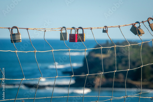 Love locks left on fence at Lennox Head lookout, NSW Australia photo