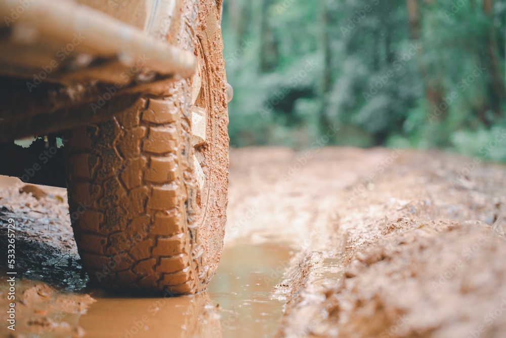 Dirty offroad car, SUV covered with mud on countryside road, Off-road tires, offroad travel and driving concept. Dirty offroad car, SUV covered with mud on countryside road, Off-road tires, offroad travel and driving concept.