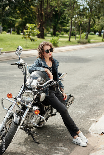 Mature Woman Leaning on Motorcycle