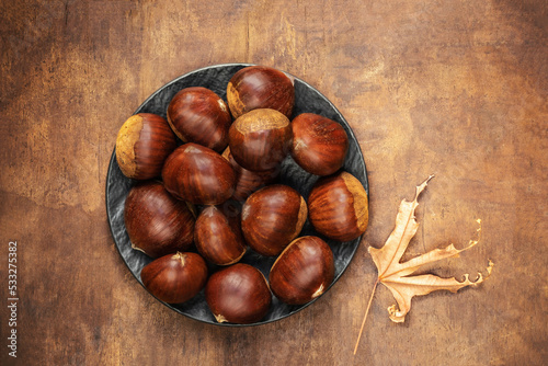 Foto Chestnuts on an old ructic background