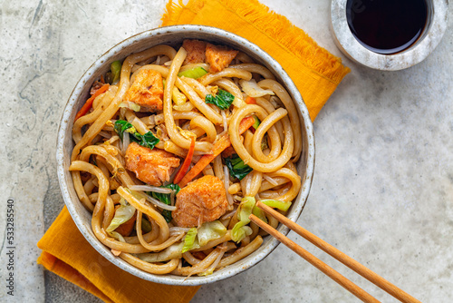 Stir Fried Yaki Udon Noodles with Salmon Fish, Vegetables and Soy-based Sauce. Japanese food. Top view. photo