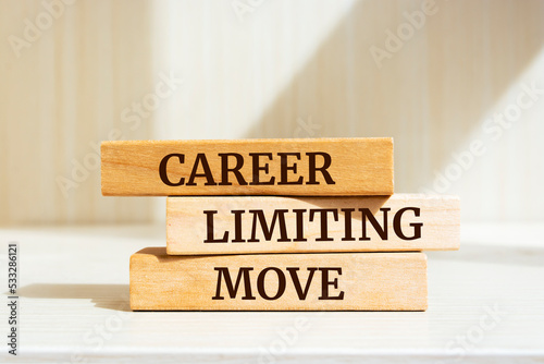 Wooden blocks with words 'CAREER LIMITING MOVE'. Business concept