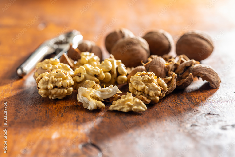 Peeled walnut on wooden table. Peeled walnut on wooden table.