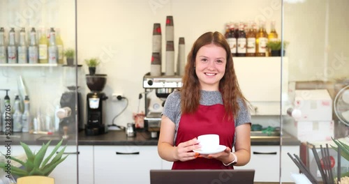 Female barista posing with happy emotion to camera. Happy barista success to start up he business.