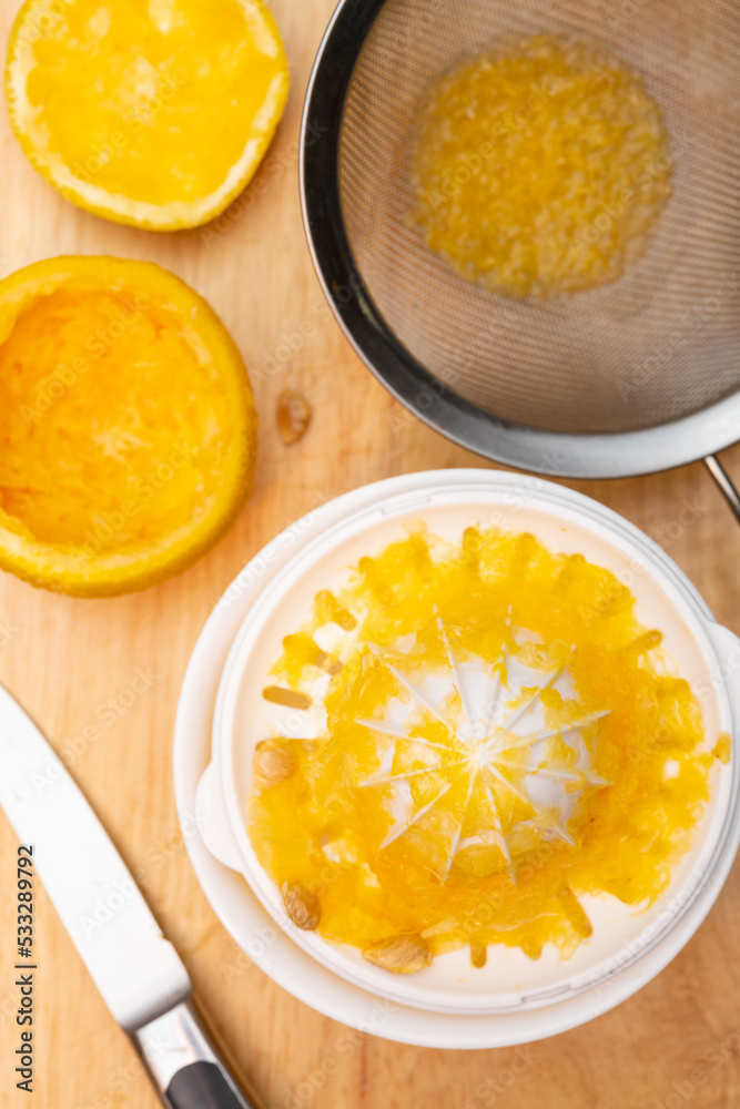 making fresh orange juice at home vertical composition making fresh orange juice at home vertical composition