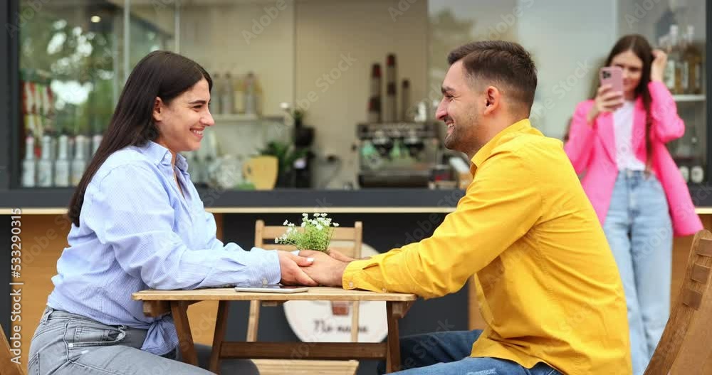 Happy diverse couple talking and drinking takeaway coffees by food truck. Happy diverse couple talking and drinking takeaway coffees by food truck.