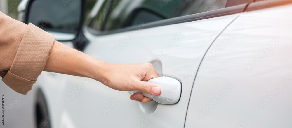 Hand holding smart car handle and opening a door. Transport, travel, service and car rental concept Hand holding smart car handle and opening a door. Transport, travel, service and car rental concept