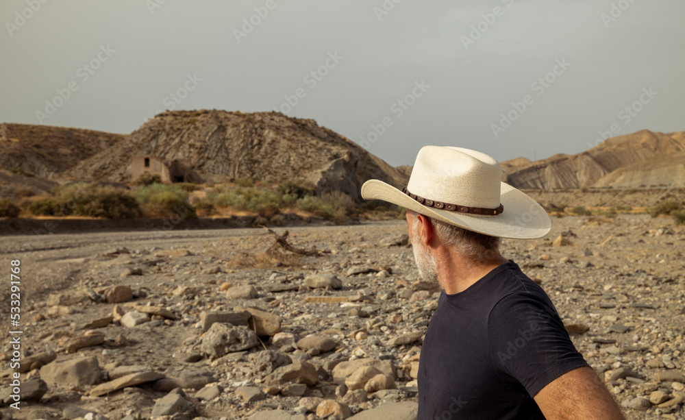 Adult man in cowboy hat in desert. Almeria, Spain Adult man in cowboy hat in desert. Almeria, Spain