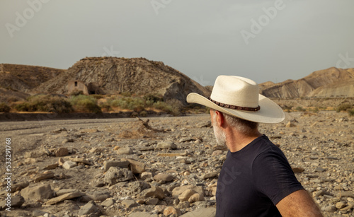 Adult man in cowboy hat in desert. Almeria, Spain