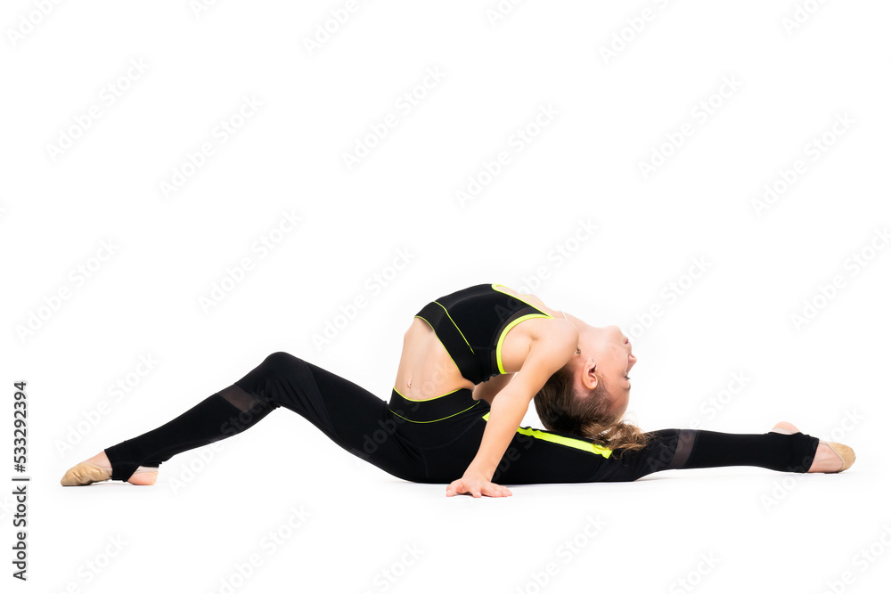 A little girl gymnast in a black sports gymnastic suit does acrobatic exercises isolated on a white background with space for text or logo. Flexibility and stretching - healthy lifestyle concept