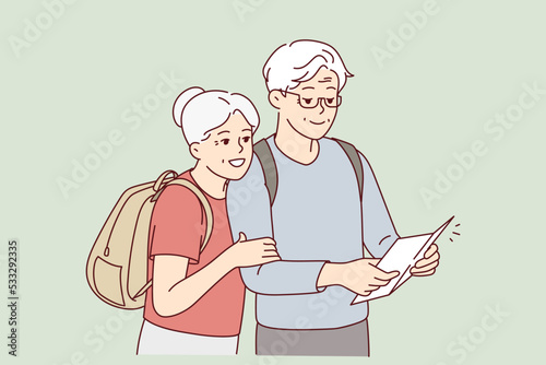 Smiling mature couple with backpacks look at paper map travel together. Happy elderly man and woman travelers look on vacation. Vector illustration. 