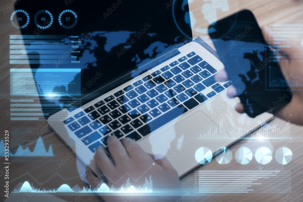 businessman hand using laptop keyboard and smartphone with abstract map and business chart hologram on blurry background. Investor, finance and financial dashboard concept. Double exposure. businessman hand using laptop keyboard and smartphone with abstract map and business chart hologram on blurry background. Investor, finance and financial dashboard concept. Double exposure.