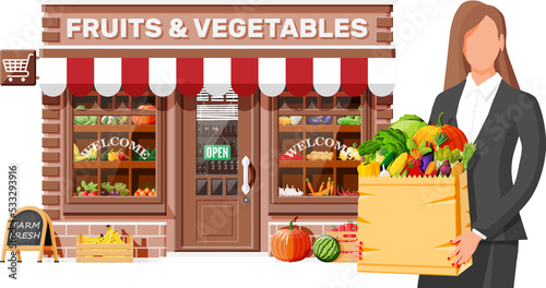 Fruit and vegetable store facade with woman