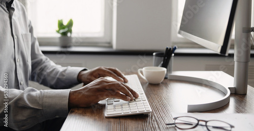 Man hands typing on computer keyboard closeup panoramic banner, businessman or student using laptop at home, online learning, internet marketing, working from home, office workplace, freelance concept photo