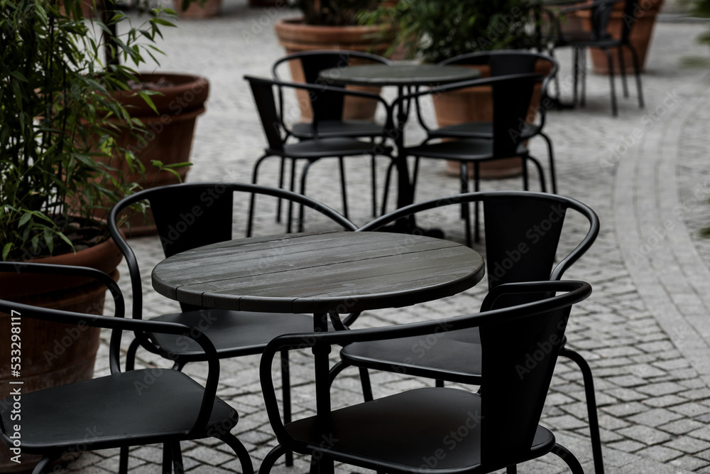 empty black tables and chairs of restaurant