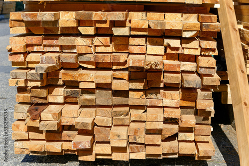 Blocks of pine sawn timber for the construction of roof houses and cottages stacked on the lumberyards site  ready for sale
