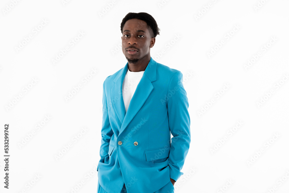 Serios african american man posing on white background in studio isolated looking at camera holding arms in pocket wearing beautiful blue smart costume. Serios african american man posing on white background in studio isolated looking at camera holding arms in pocket wearing beautiful blue smart costume.
