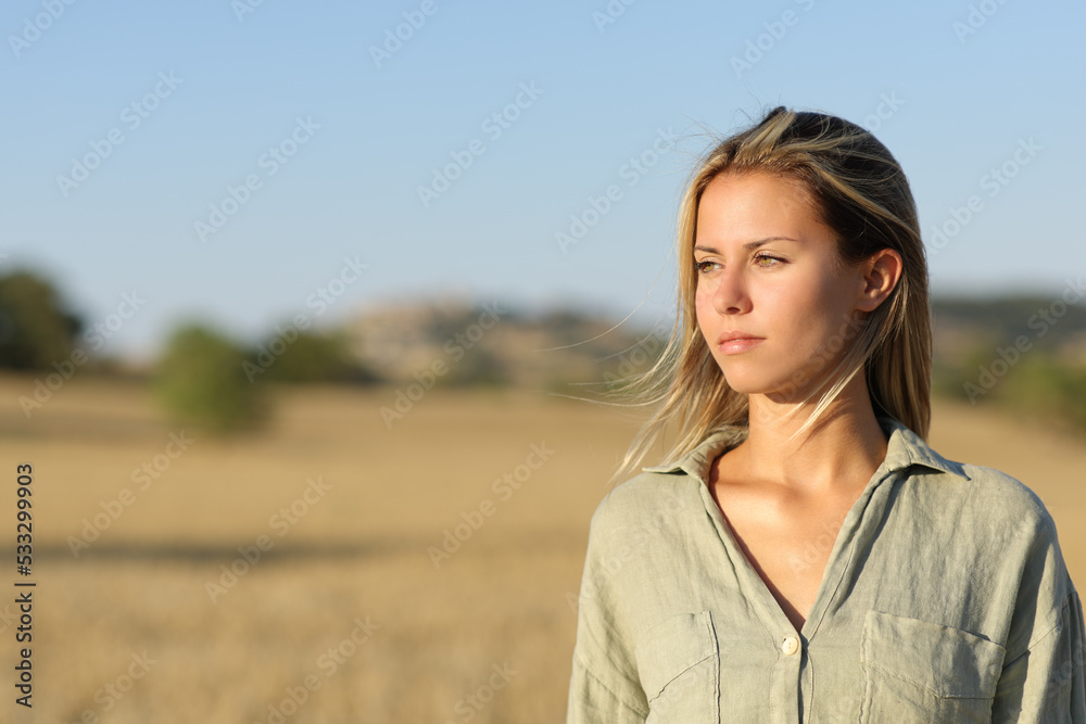 Woman in a field looking at side