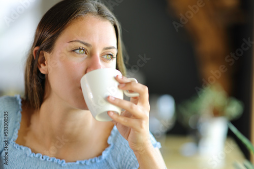 Woman distracted drinking coffee