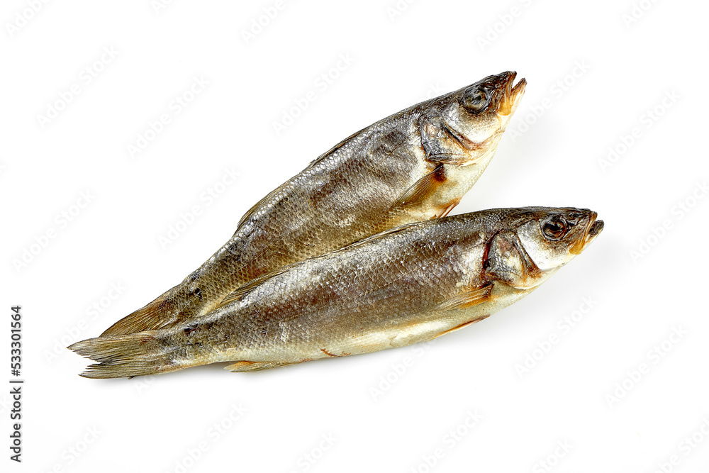 Dried mullet. Close-up, selective focus. White background. Dried mullet. Close-up, selective focus. White background.